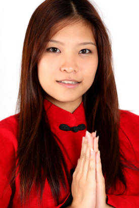 Thailand Customs: Thai lady demonstrates Thai Wai