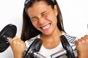 Thai lady working out with weights for fitness